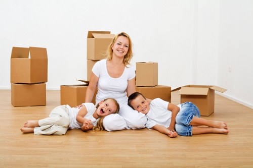 Removal company loading household items with protective covers